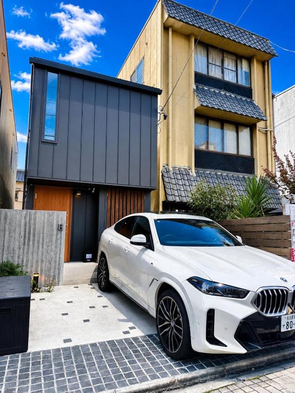 a white car parked in front of a house at Villa Monica Premium in Nagoya