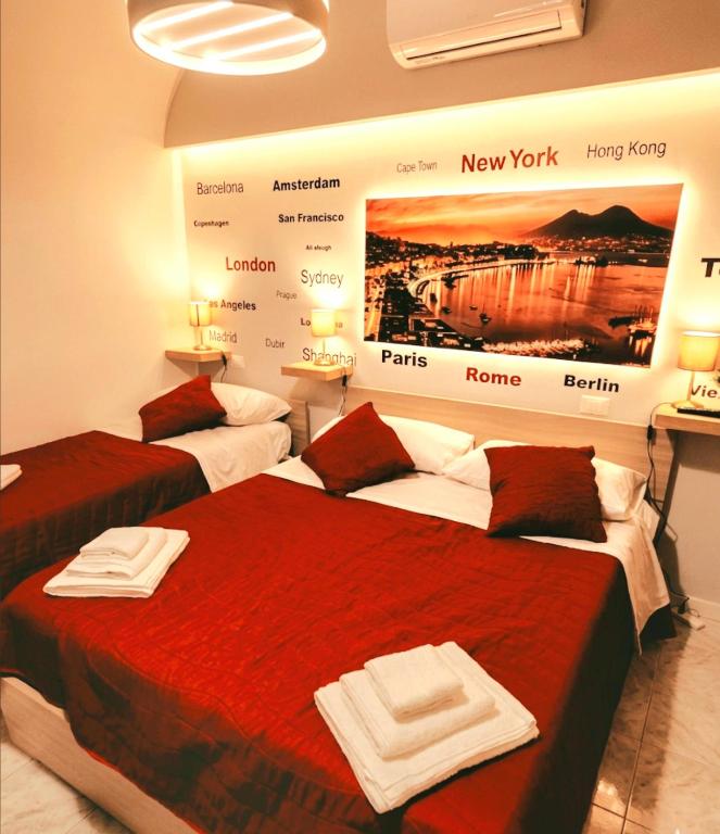 two beds in a room with a poster on the wall at PURGATORIO HOUSE in Naples