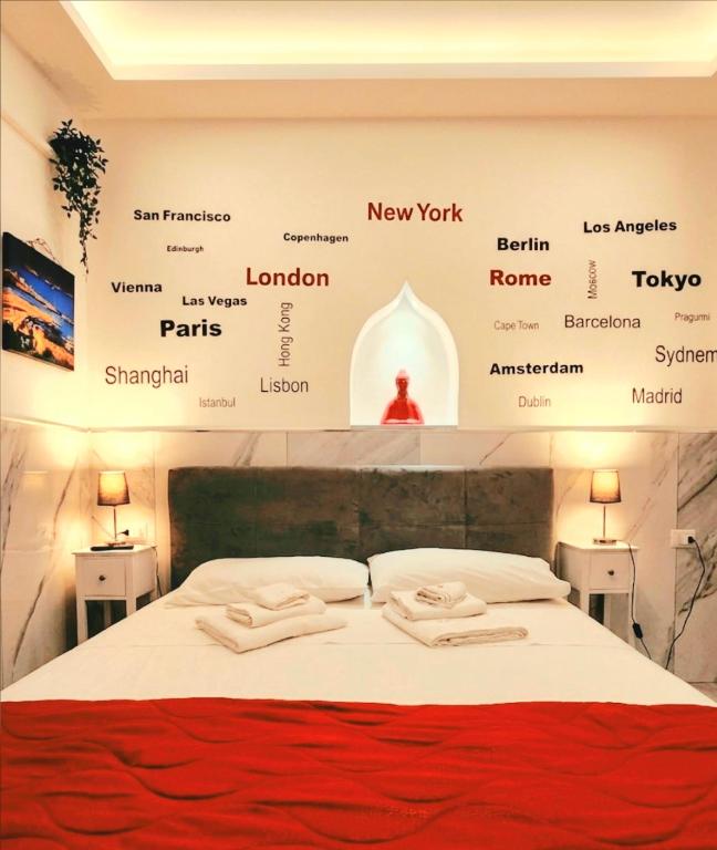 a bedroom with a bed with a poster on the wall at Suite SAN GENNARO in Naples