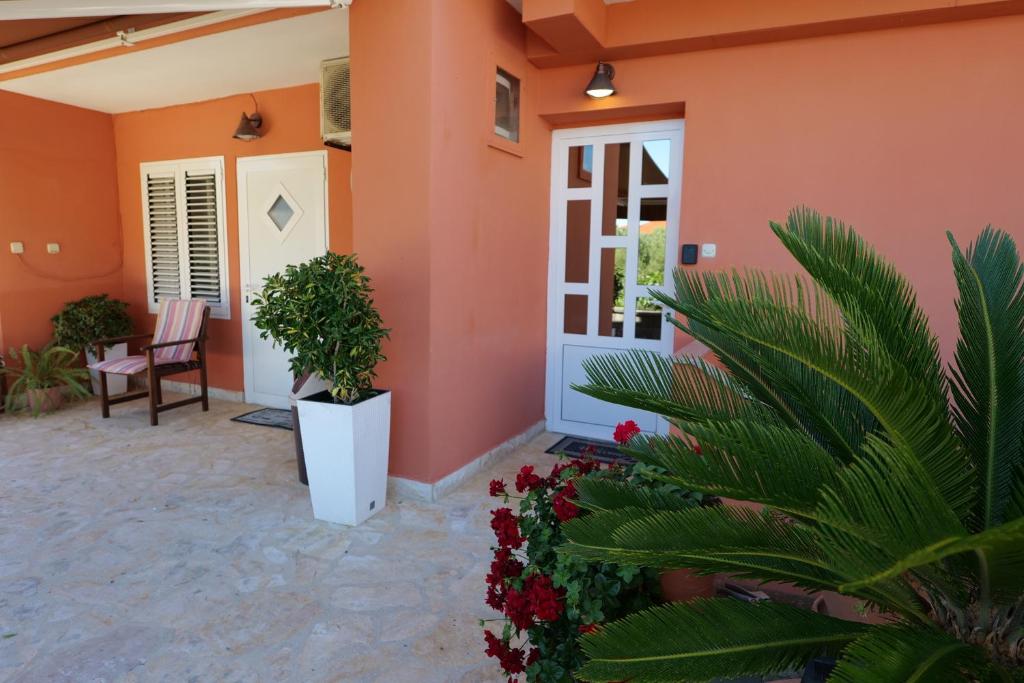 a front door of a house with plants and flowers at Apartment Jugo in Preko