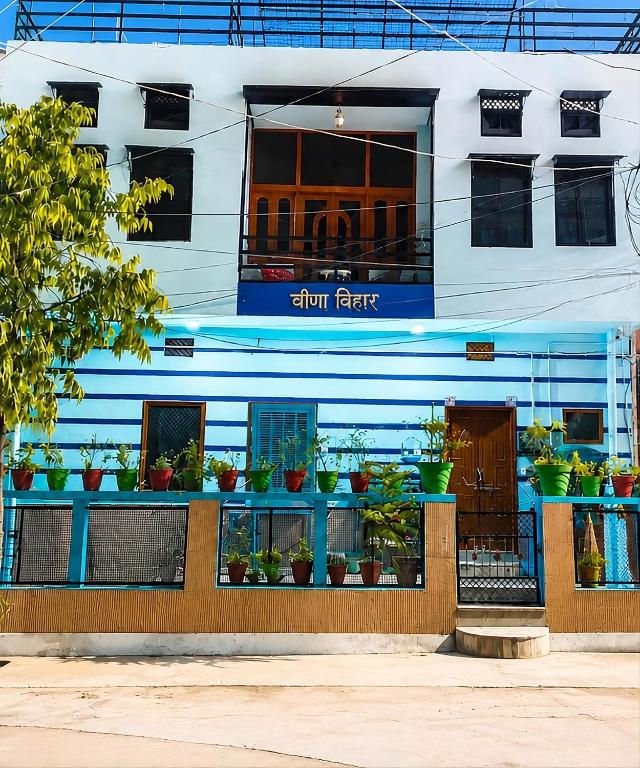 a building with potted plants on the front of it at Veena Vihar Homestay in Jodhpur