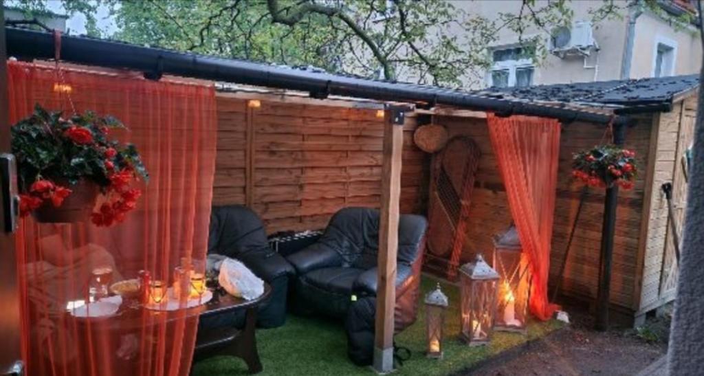 a shed with a chair and a table in a yard at Oliwa in Gdańsk