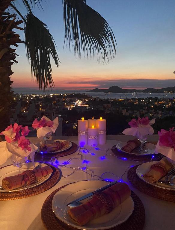a table with plates of food and candles on it at Oryx Homes & Villas in Bodrum City