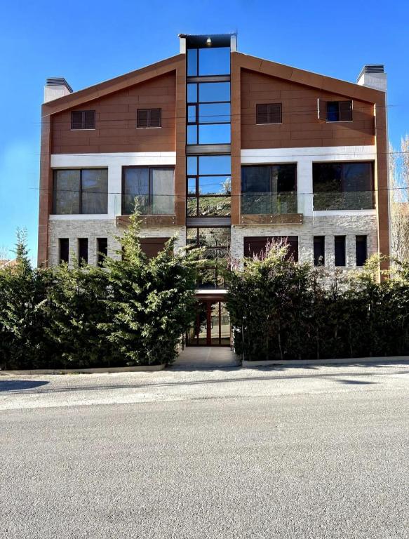 a large building with a lot of windows at White Bloom - Kfardebian 6836 in Kfardebian