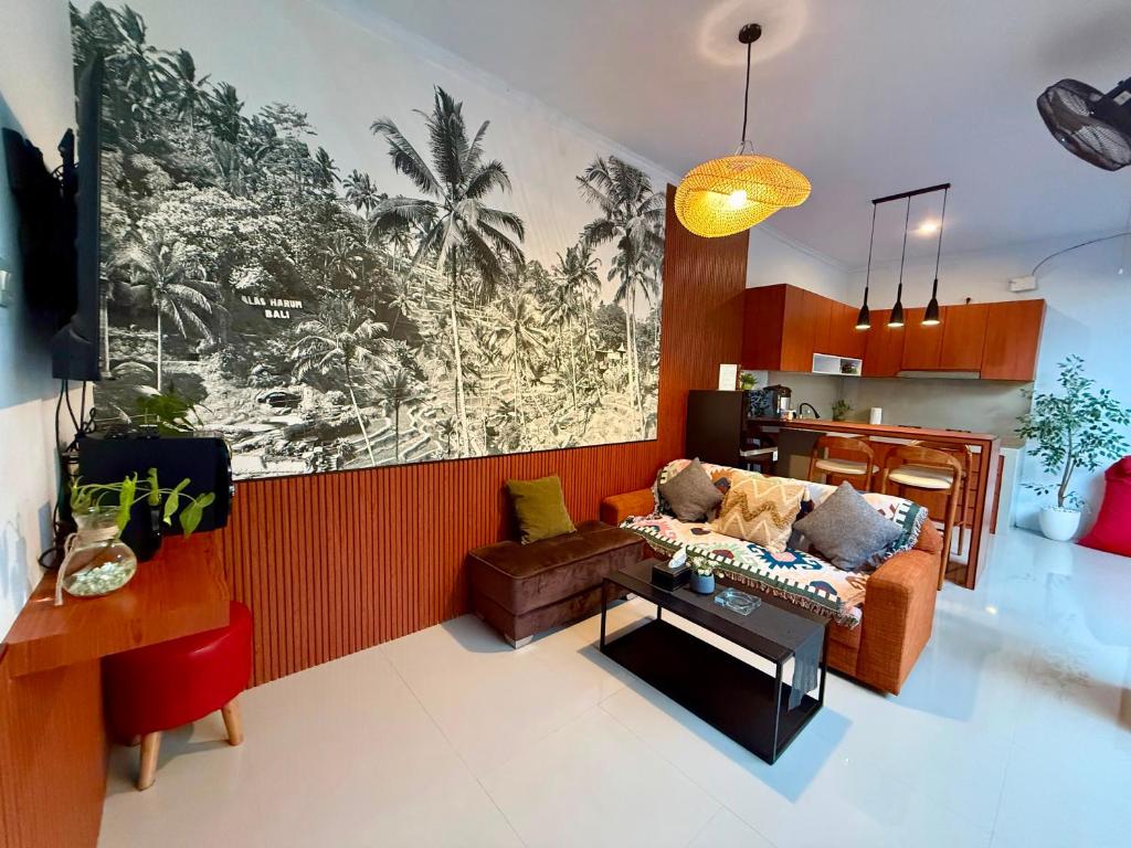 a living room with a couch and a table at Erindra Villa in Pesanggaran