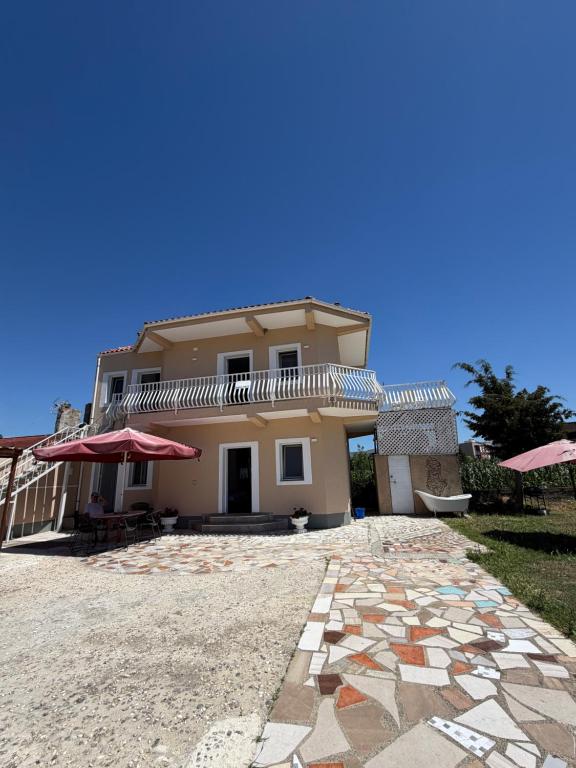 a house with a stone walkway in front of it at Lalëz Villa Hoxha in Fushë-Draç