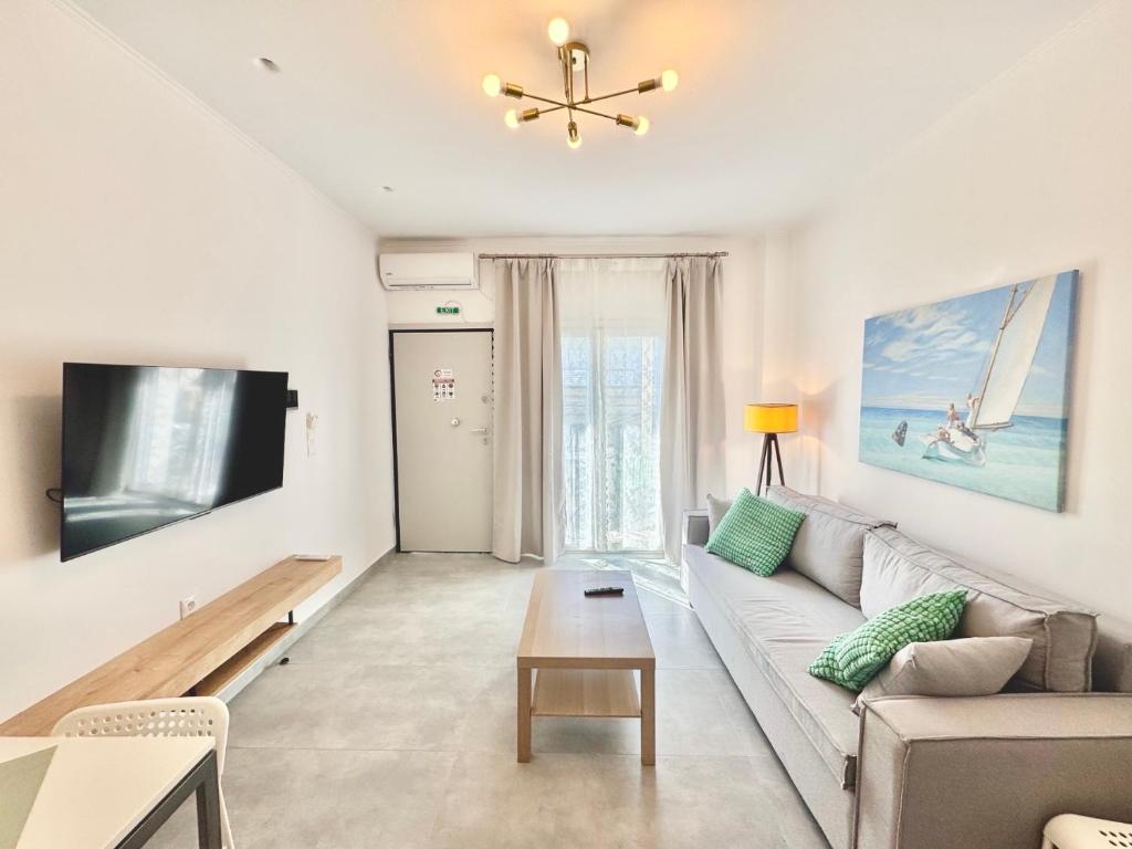 a living room with a couch and a tv at Vrachati Blue in Vrachati