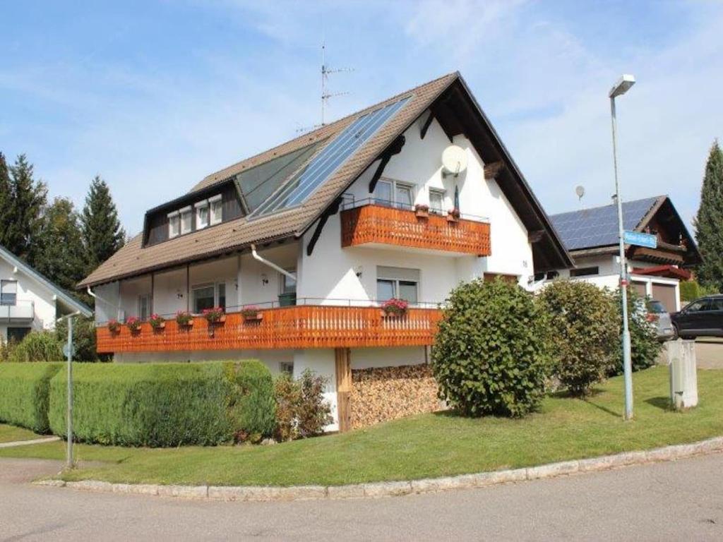 a house with a roof with a dog on the balcony at Terrassenwohnung, Herrischried in Herrischried