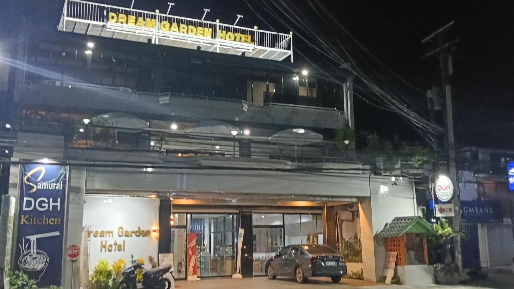 a car parked in front of a building at night at Dream Garden Hotel in Solano