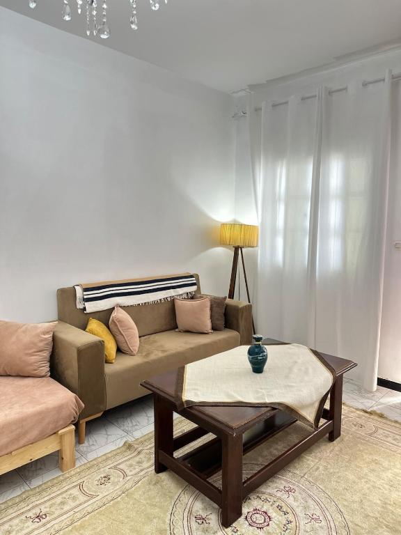 a living room with a couch and a coffee table at appartement cozy in Kolea