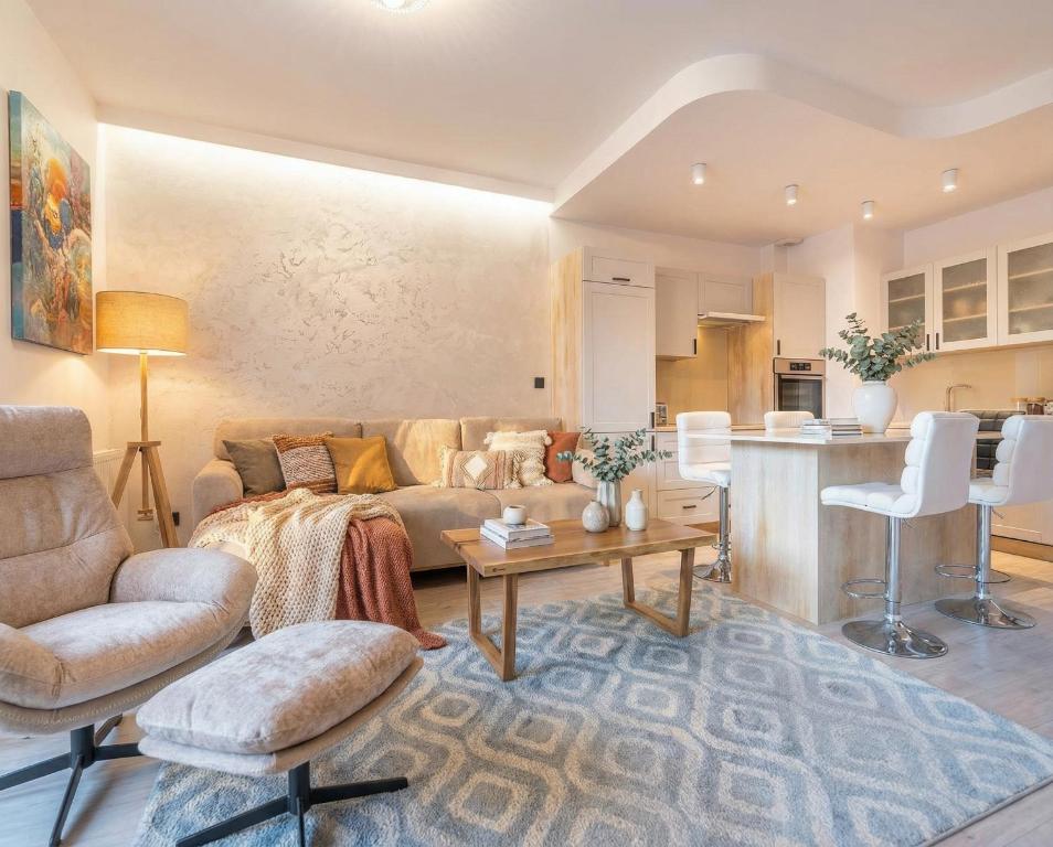 a living room with a couch and a table at City Lights Apartments in Krakow
