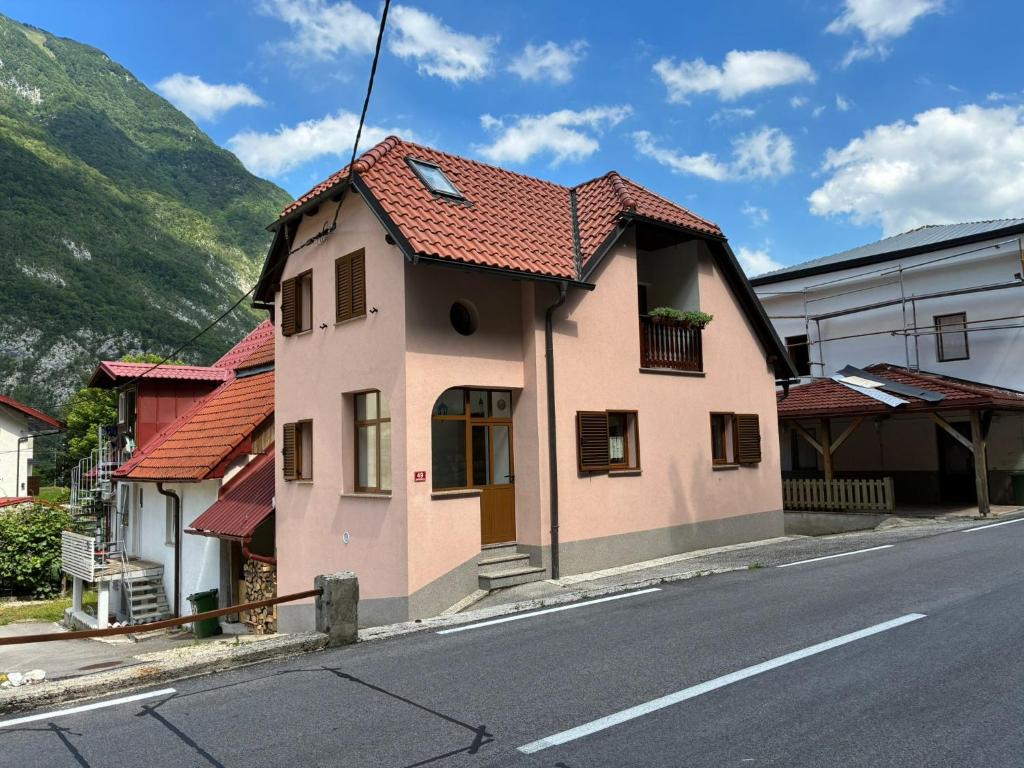 a small pink house on the side of a street at Holiday Home Katja in Srpenica