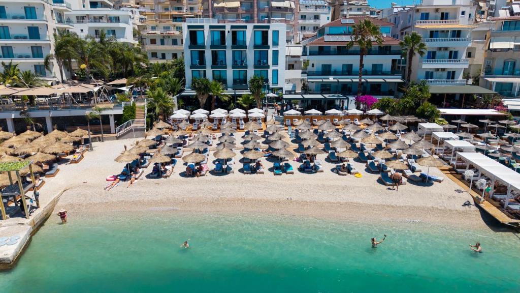 an aerial view of a beach with umbrellas and chairs at Vila Era Beach in Sarandë