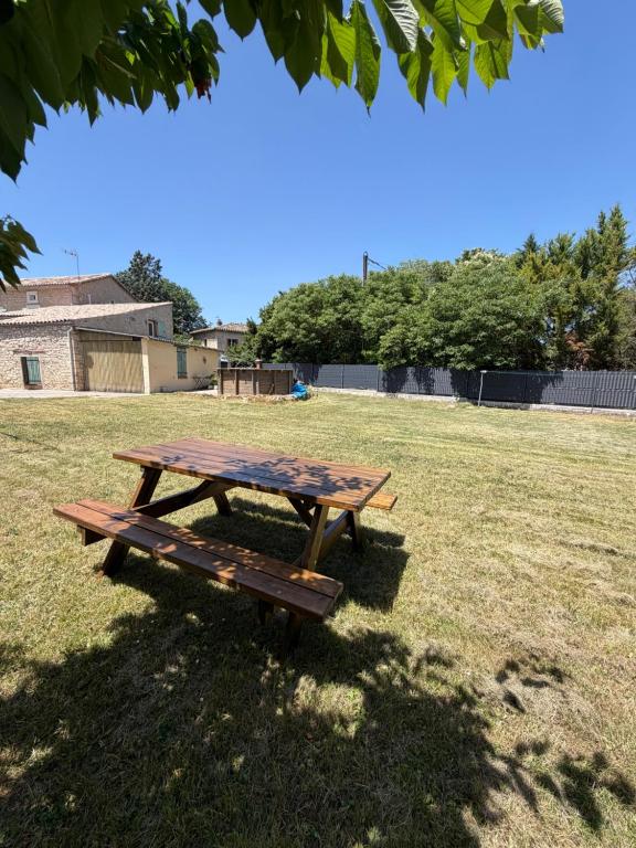 a picnic table sitting in a grass field at Gîte de Fertés in Amarens