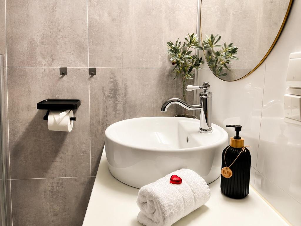 a bathroom with a sink and a mirror at KB - Apartment in Sørvågen