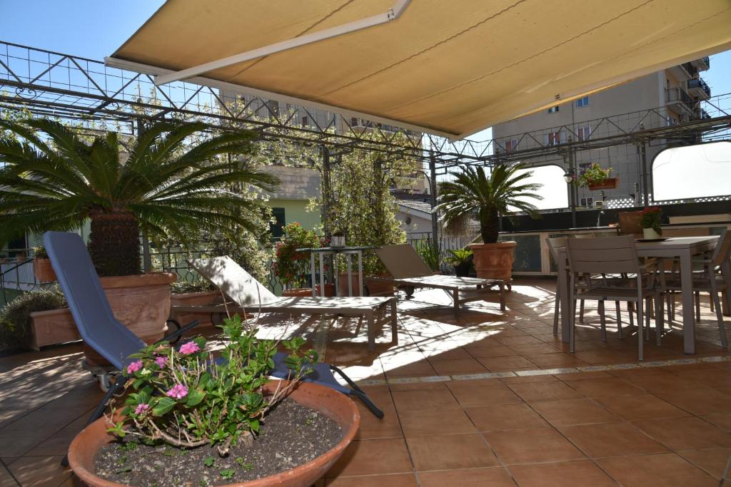 a patio with tables and chairs and potted plants at appartamento Macchia in Agropoli