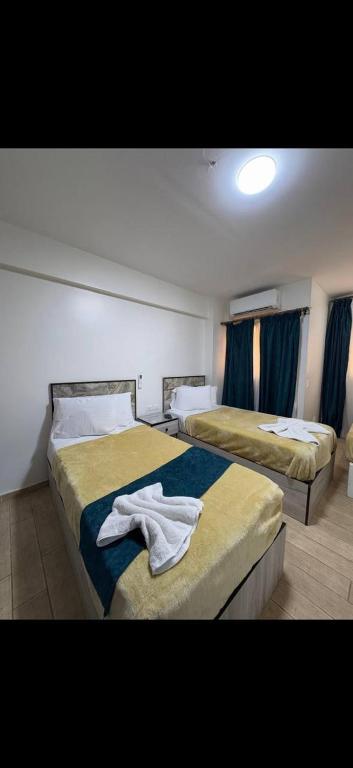 a hotel room with two beds with towels on them at Osiris Cairo Hotel Downtown in Cairo