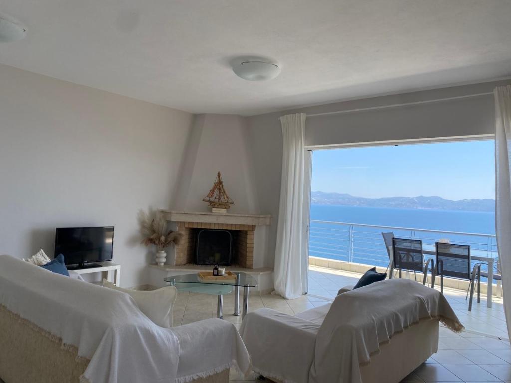 a living room with a view of the ocean at Blue Deck Theologos in Theologos