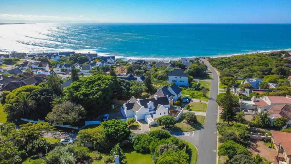 an aerial view of a house with the ocean at Eden on Walton 1 in Sea Vista