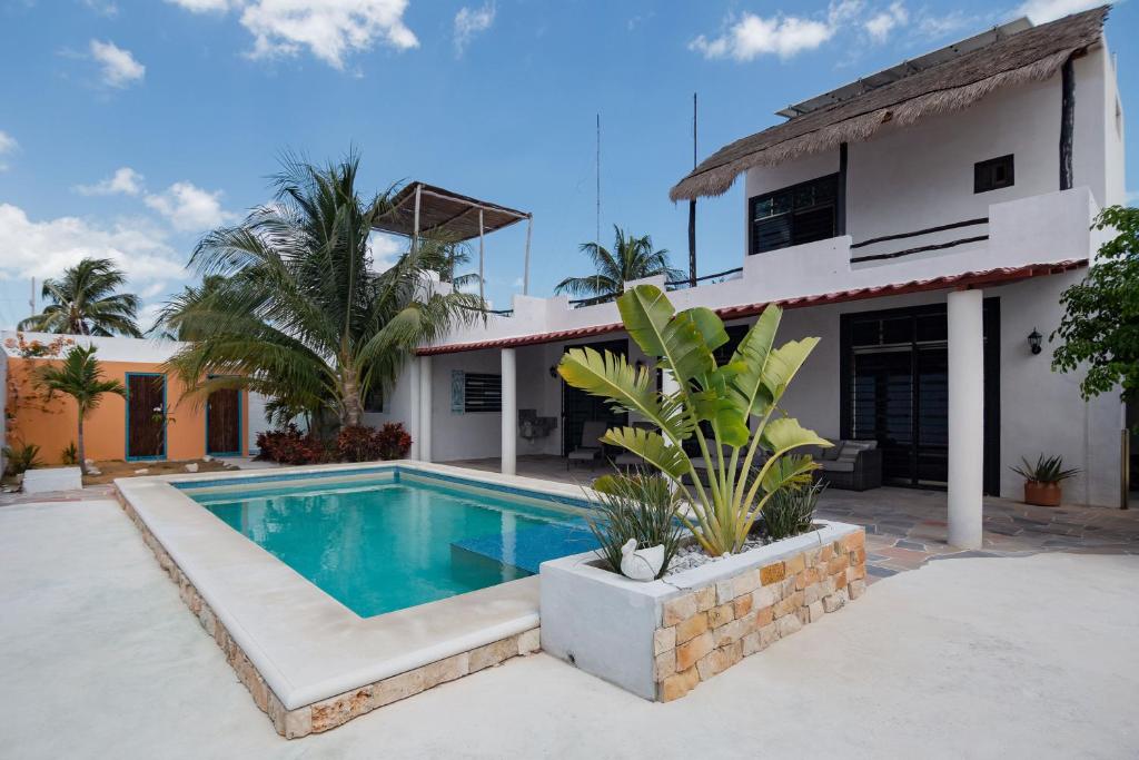 a swimming pool in front of a house at Private Pool, Beach Access 3BR Sleeps 6 in Chelem