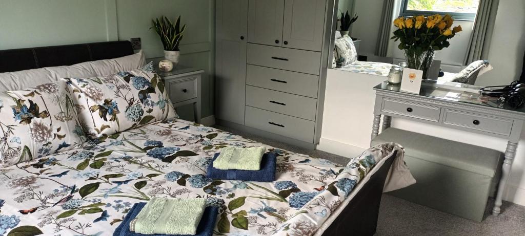 a bedroom with a bed and a dresser at Dunfolan House in Dundrum