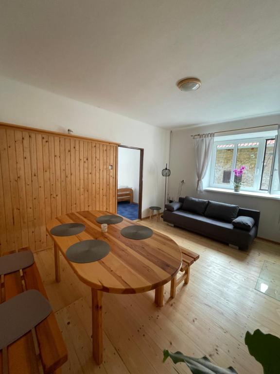 a living room with a wooden table and a couch at Leon in Lomnice nad Lužnicí
