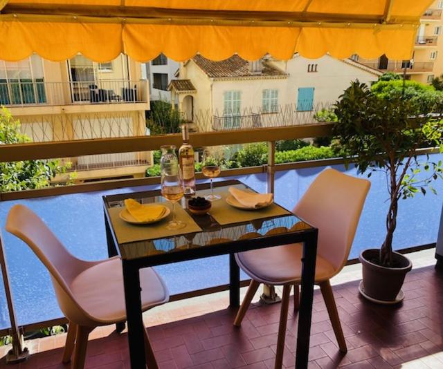 a table and chairs sitting on a balcony with a view at Blue Riviera in Roquebrune-Cap-Martin