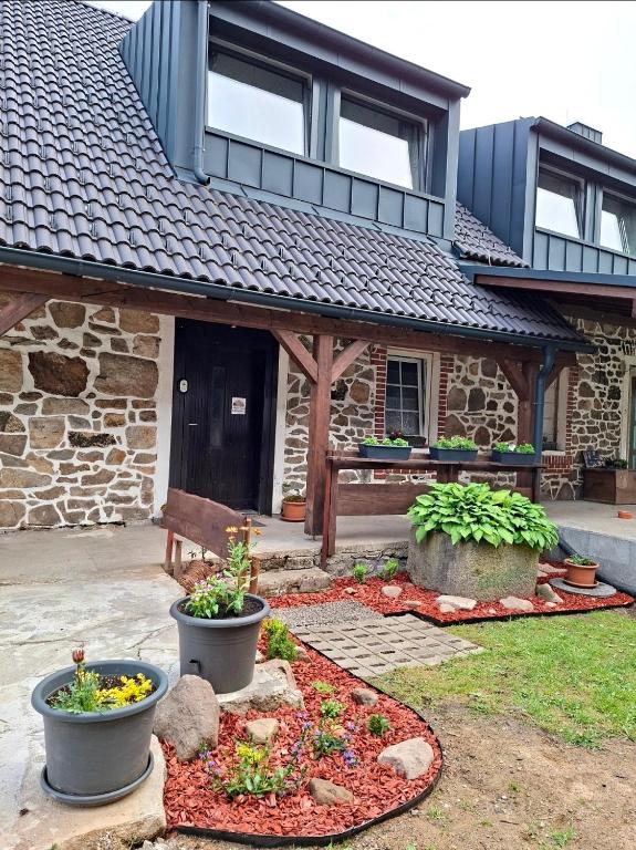 a house with a garden in front of it at Apartmán Kameňák in Stožec