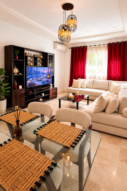 a living room with a couch and a tv at Modern Apartment - Center of Fez in Fez