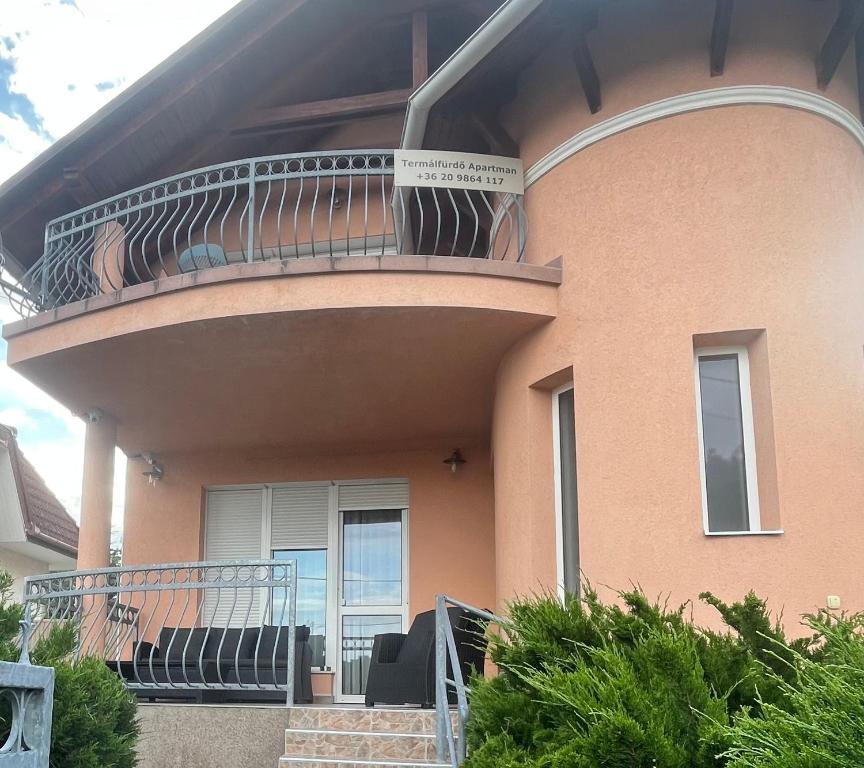 a house with a large deck on top of it at Termálfürdő Apartman Igal -130 méterre a fürdőtől in Igal