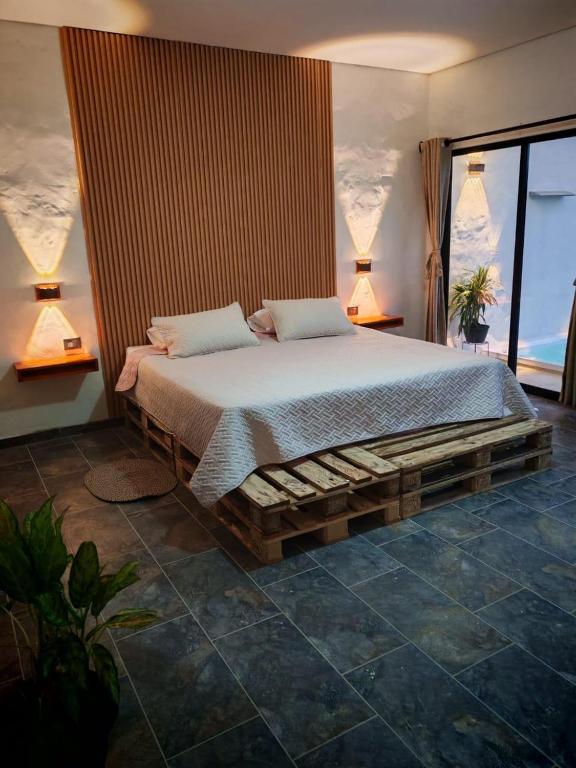 a bedroom with a large bed with two pillows at Villa Milú Refugio boutique in Guaduas