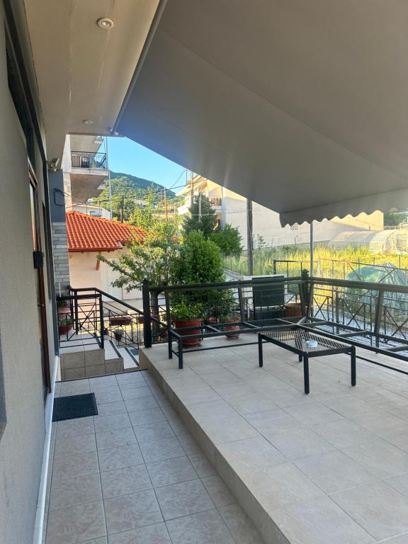 a balcony with benches and a view of the mountains at Letsios Steel1 in Kalabaka