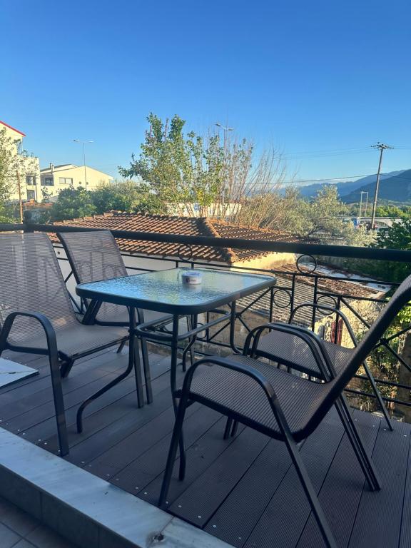 a table and chairs sitting on a deck at Letsios Steel2 in Kalabaka