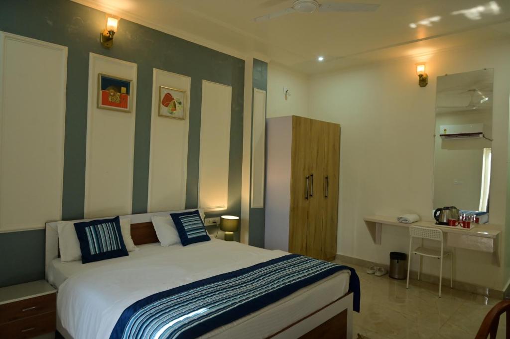 a bedroom with a bed with blue and green stripes at shangrila stay in Bodh Gaya