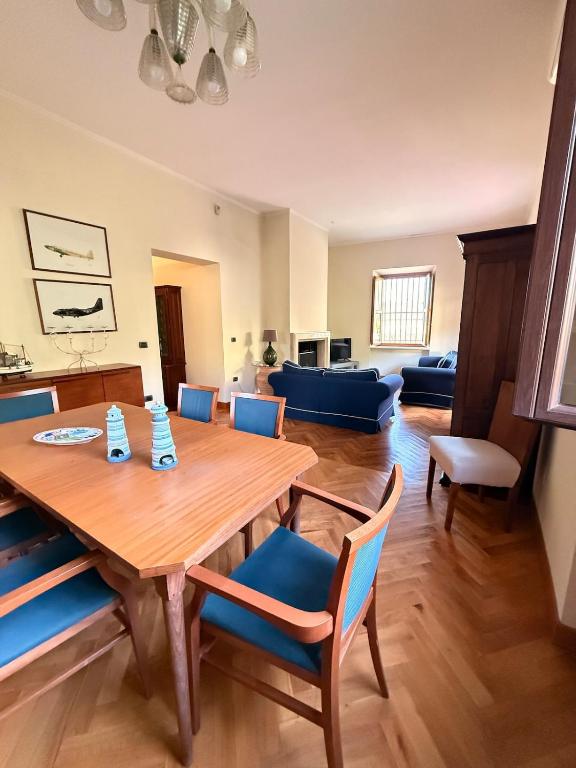 a living room with a wooden table and blue chairs at Relax on the Sea in Pizzo