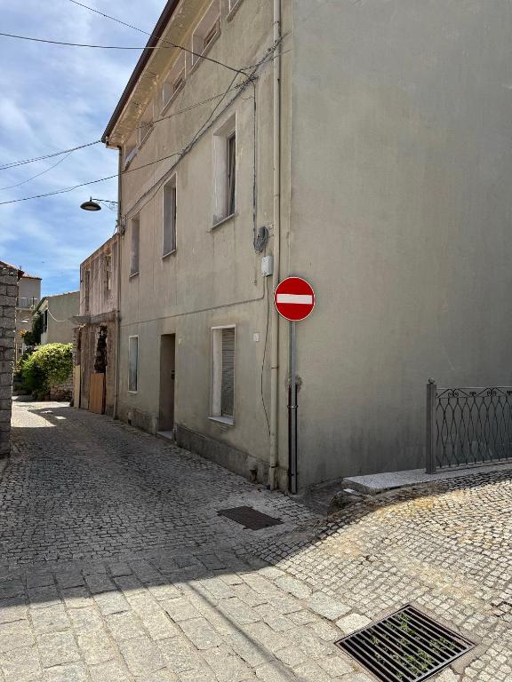 a red stop sign in front of a building at La Funtanella in Aggius