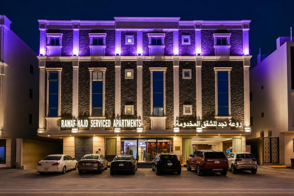 a building with cars parked in a parking lot at روعة نجد المغرزات in Riyadh