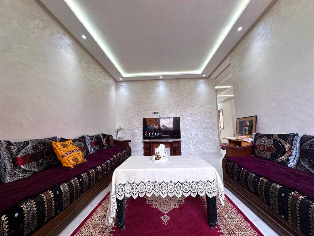 a living room with two couches and a table at Apartment in Azemmour in Azemmour