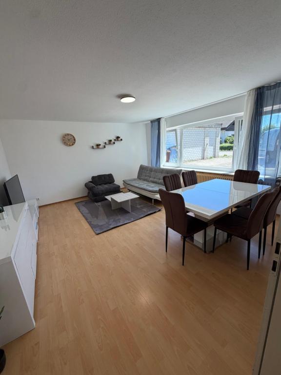 a living room with a table and a couch at Modern Living - Tuttlingen in Tuttlingen