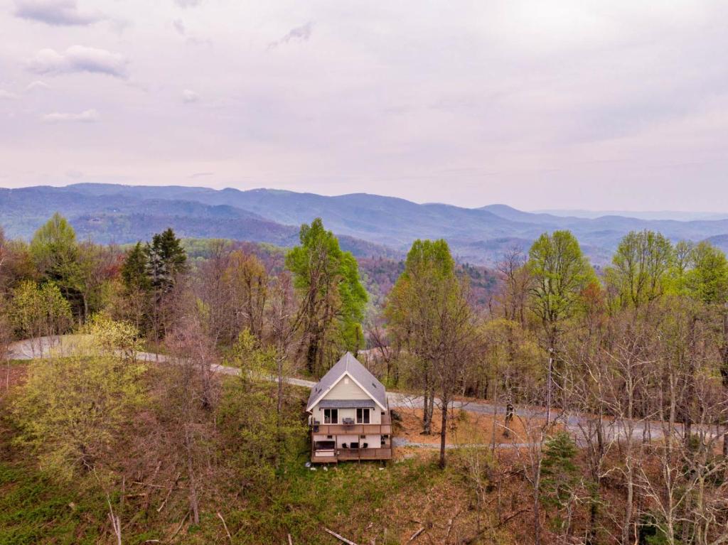 a cabin in the woods with a view of the mountains at Calling Me Home in Lenoir