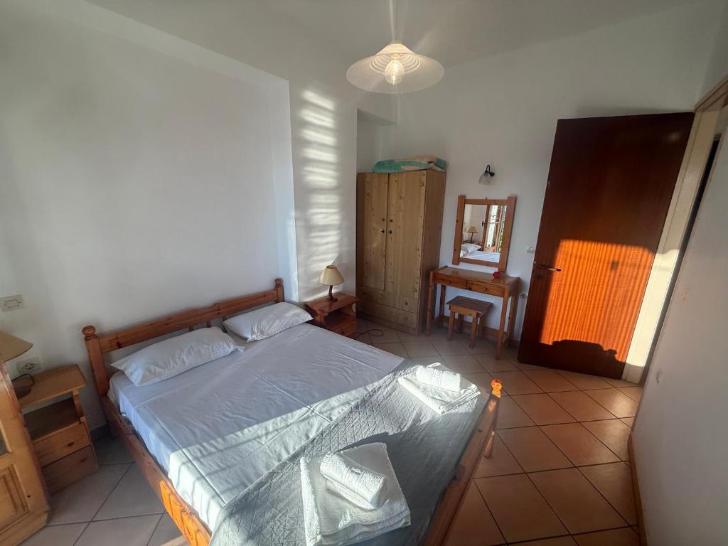 a bedroom with a bed and a mirror in it at Villa Rebecca in Agios Gordios