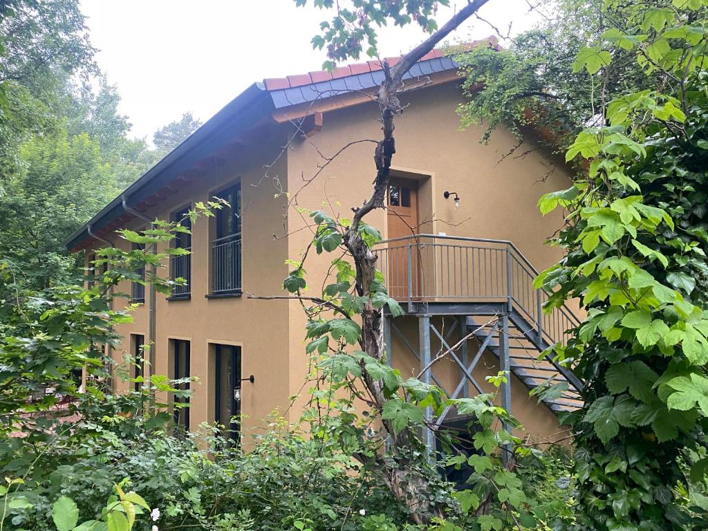a building with a staircase on the side of it at Ferienwohnung Zum Bachsee in Chorin