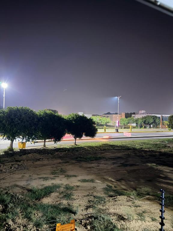 a street with trees on the side of a road at Private villa in Lahore