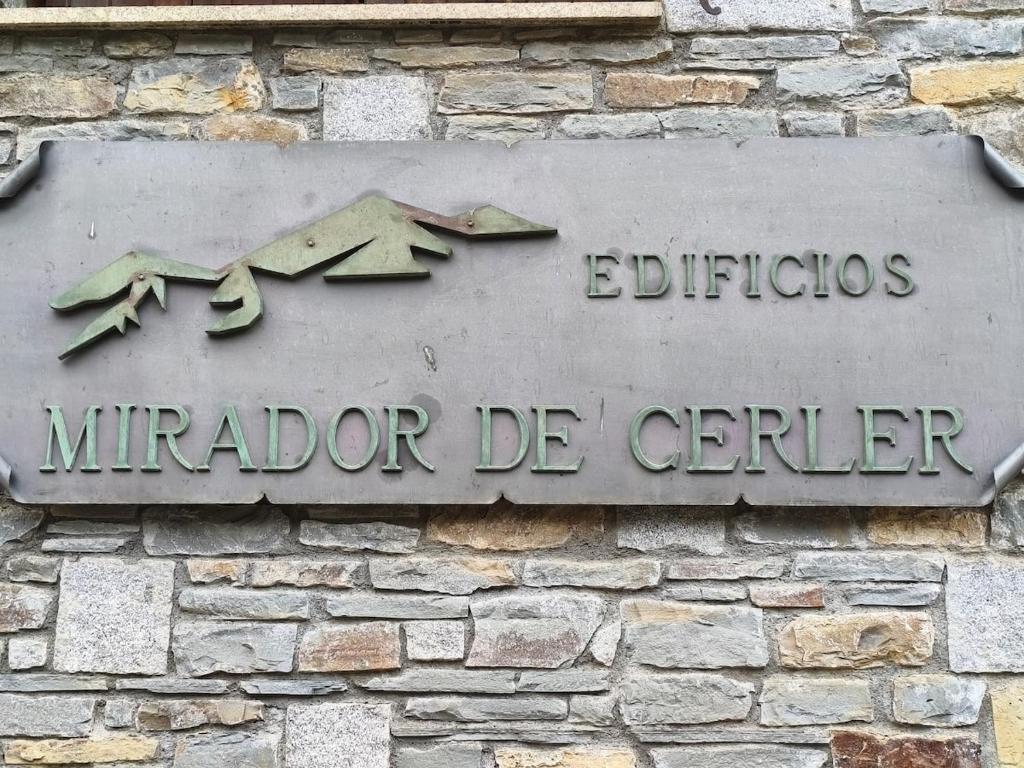 a sign on the side of a brick building at Mirador de Cerler in Cerler