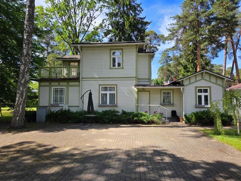 a large white house with a large driveway at Baltic Beach Villa I in Jūrmala