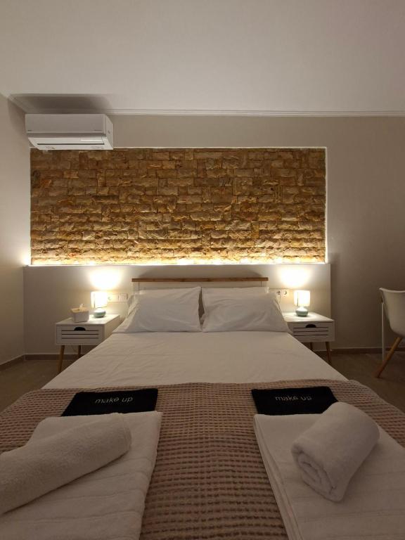 a bedroom with a large bed with two towels on it at Elia Studios 2 in Nydri