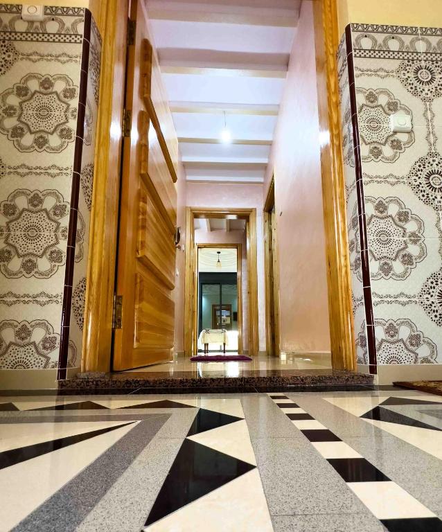 a hallway in a building with a tile floor at Catrass Oualidia Apartments in Oualidia