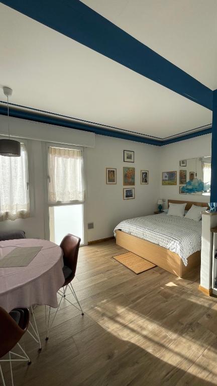 a bedroom with a bed and a table in it at In Blu Santo Ospedale in Padova