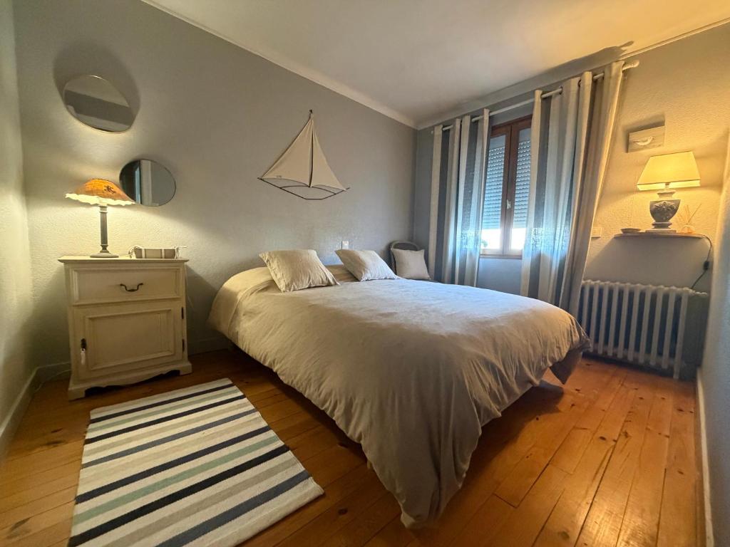 a bedroom with a white bed and a window at Tredd in La Rochelle