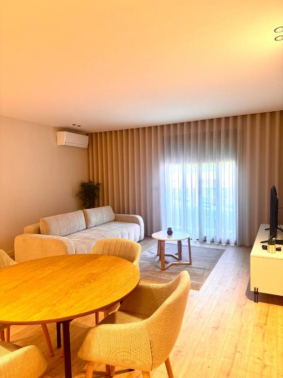 a living room with a couch and a table at Apartamento Cimo da Barca in Ponte da Barca